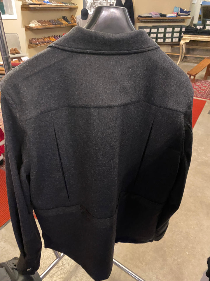Gray jacket on a mannequin in a store setting