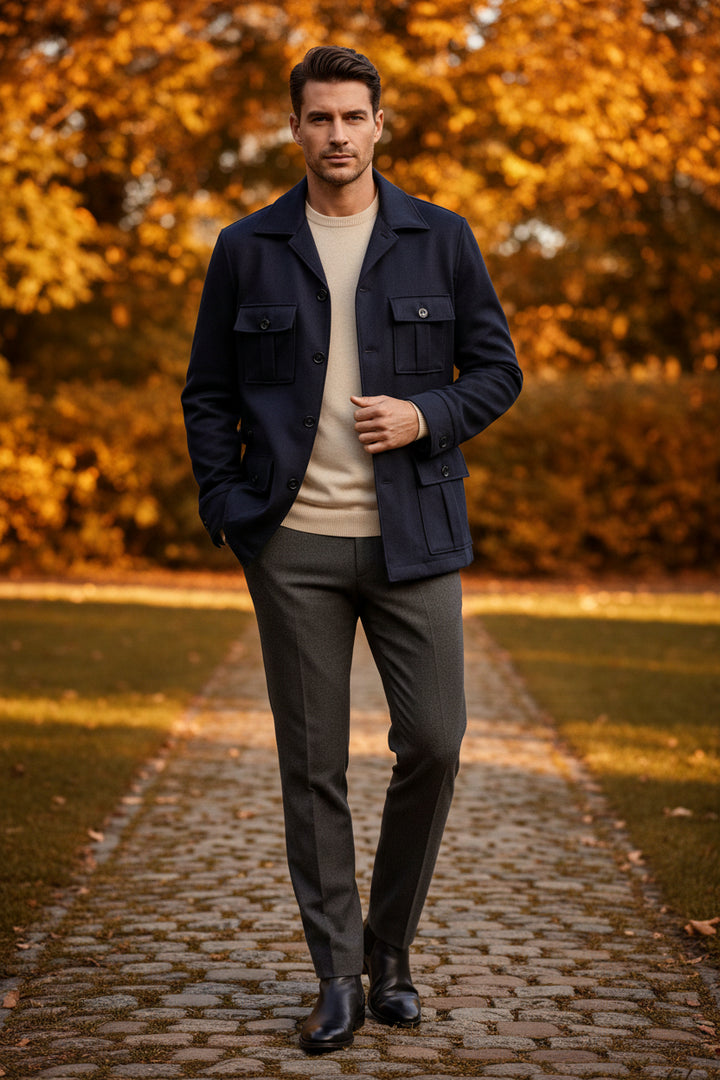 Navy blue jacket on a hanger against a beige wall